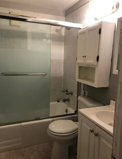 2950 North Sheffield Avenue, Unit 2F Chicago, IL 60657 - Photo 3 of 7 a bathroom with a sink a toilet and shower