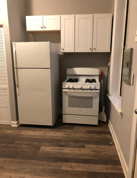 2950 North Sheffield Avenue, Unit 2F Chicago, IL 60657 - Photo 6 of 7 a kitchen with a refrigerator a stove a microwave and cabinets