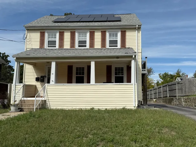 a view of a house with a yard