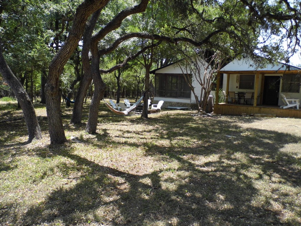 12333 B Ranch Road 12, Unit 2 Wimberley, TX 78676 - Photo 2 of 25 a view of a yard with trees in the background
