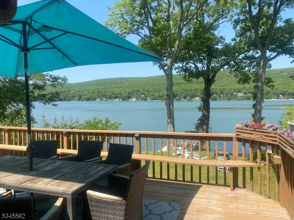 a view of a chairs and table on the wooden deck