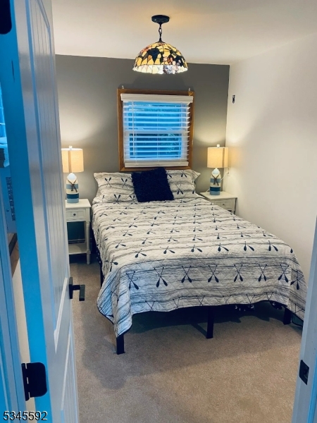 857 East Shore Road West Milford, NJ 07421 - Photo 12 of 31 a bed sitting in a bedroom next to a window