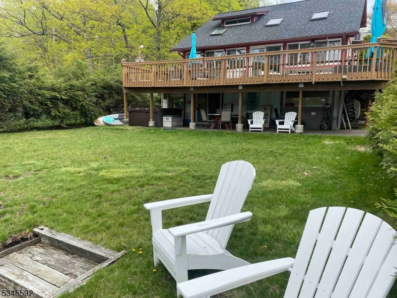 857 East Shore Road West Milford, NJ 07421 - Photo 22 of 31 a view of a house with a yard and sitting area