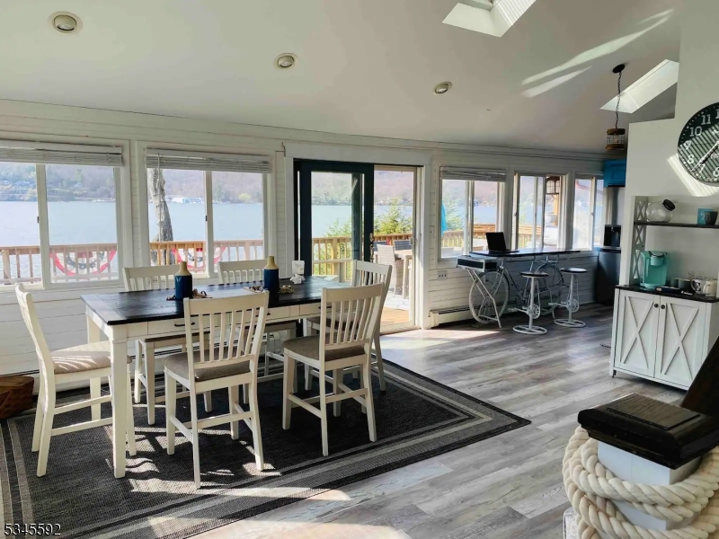 857 East Shore Road West Milford, NJ 07421 - Photo 3 of 31 a view of a dining room with furniture wooden floor and chandelier