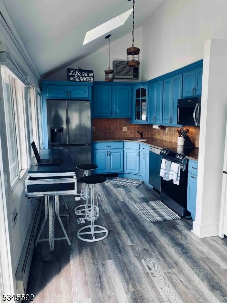 857 East Shore Road West Milford, NJ 07421 - Photo 4 of 31 a kitchen with kitchen island granite countertop a stove and a wooden floors
