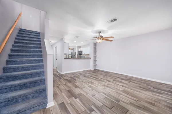 a view of a room with wooden floor and stairs