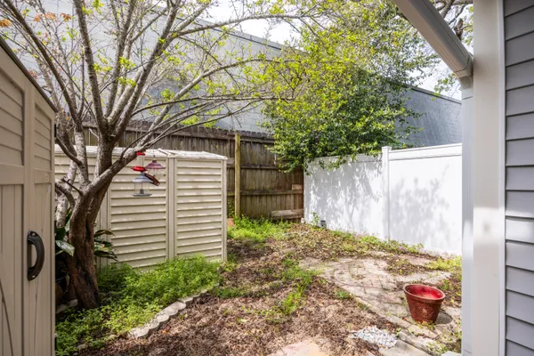 a backyard of a house with a tree