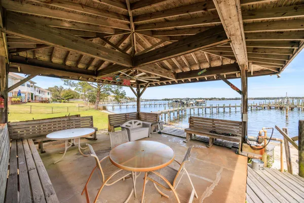 a patio with glass top table and chairs