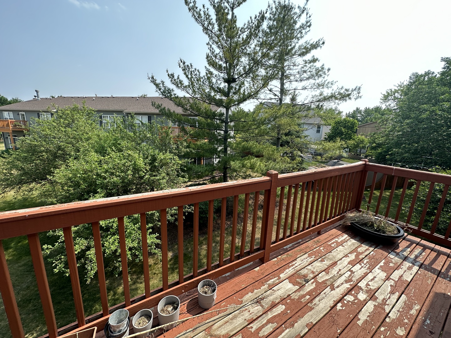 2418 Oneida Lane, Unit 2418 Naperville, IL 60563 - Photo 15 of 15 a balcony with wooden floor and trees in the back