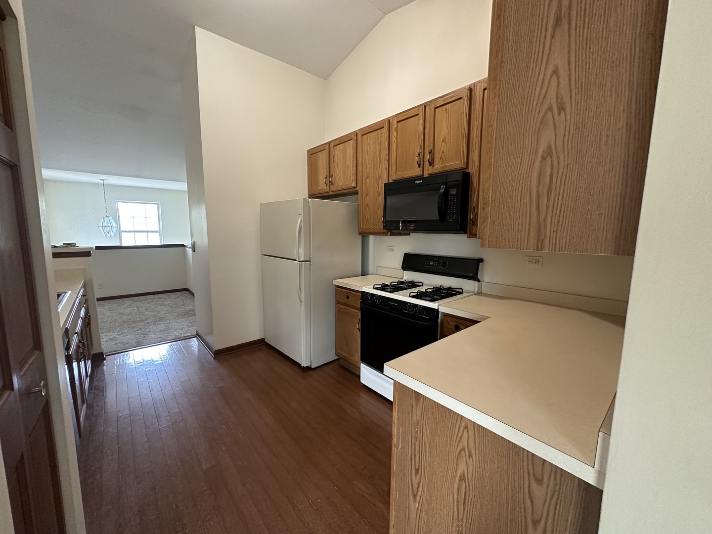 2418 Oneida Lane, Unit 2418 Naperville, IL 60563 - Photo 5 of 15 a kitchen with a refrigerator and a stove top oven