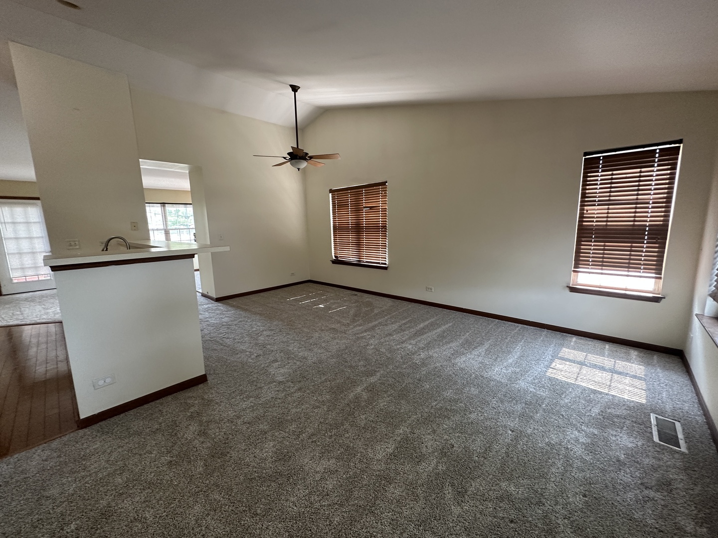 2418 Oneida Lane, Unit 2418 Naperville, IL 60563 - Photo 7 of 15 an empty room with windows and cabinet