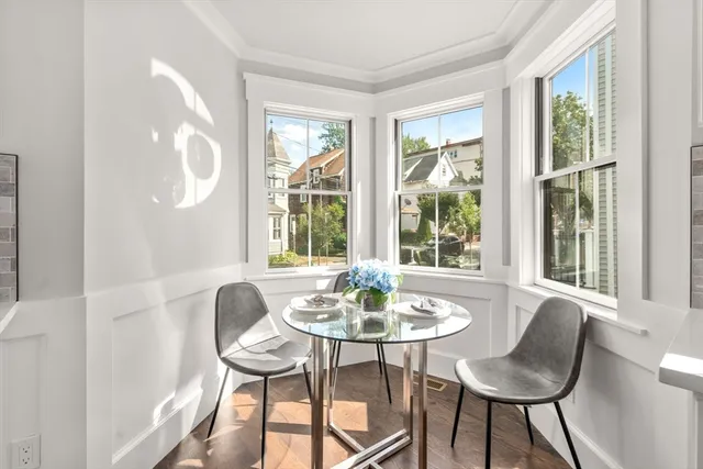 a dining room with furniture and window