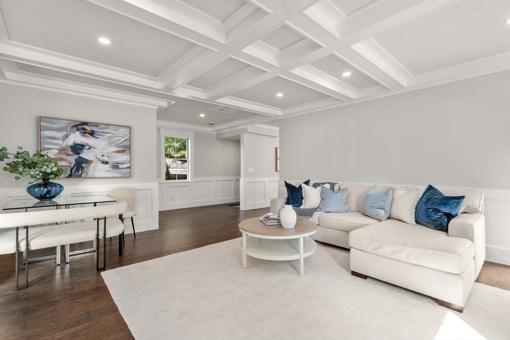 11 Macarthur Street, Unit A Somerville, MA 02145 - Photo 13 of 35 a living room with furniture and a dining table with wooden floor