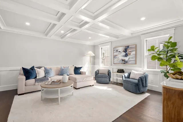 a living room with furniture potted plant and a window