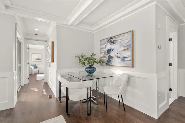 a dining room with furniture and wooden floor