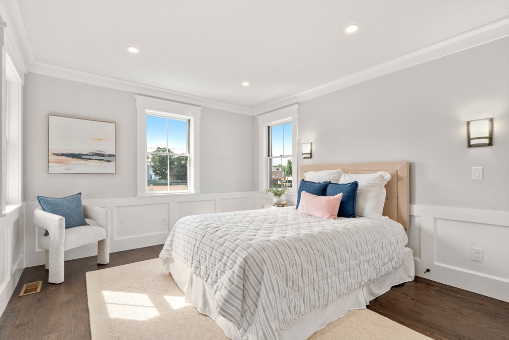 11 Macarthur Street, Unit A Somerville, MA 02145 - Photo 17 of 35 a bedroom with a bed and wooden floor