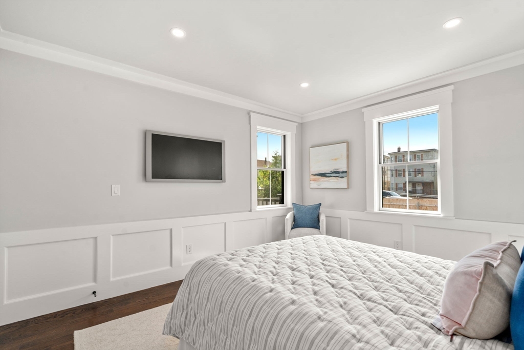 11 Macarthur Street, Unit A Somerville, MA 02145 - Photo 18 of 35 a bedroom with a bed and a flat screen tv