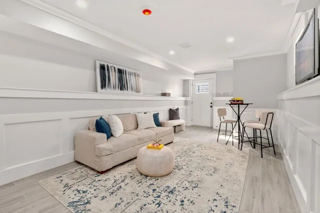 a living room with furniture and kitchen view