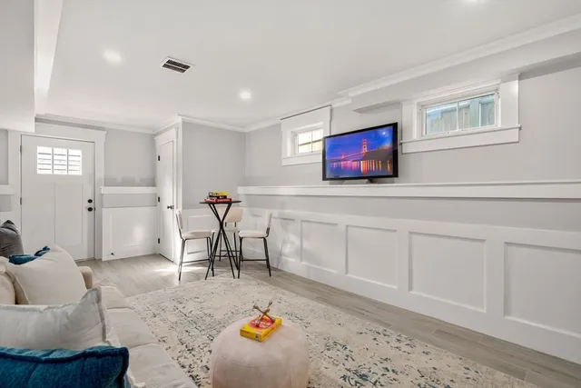 a living room with furniture and a rug