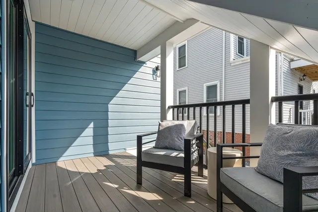 a view of a deck with chairs and wooden floor