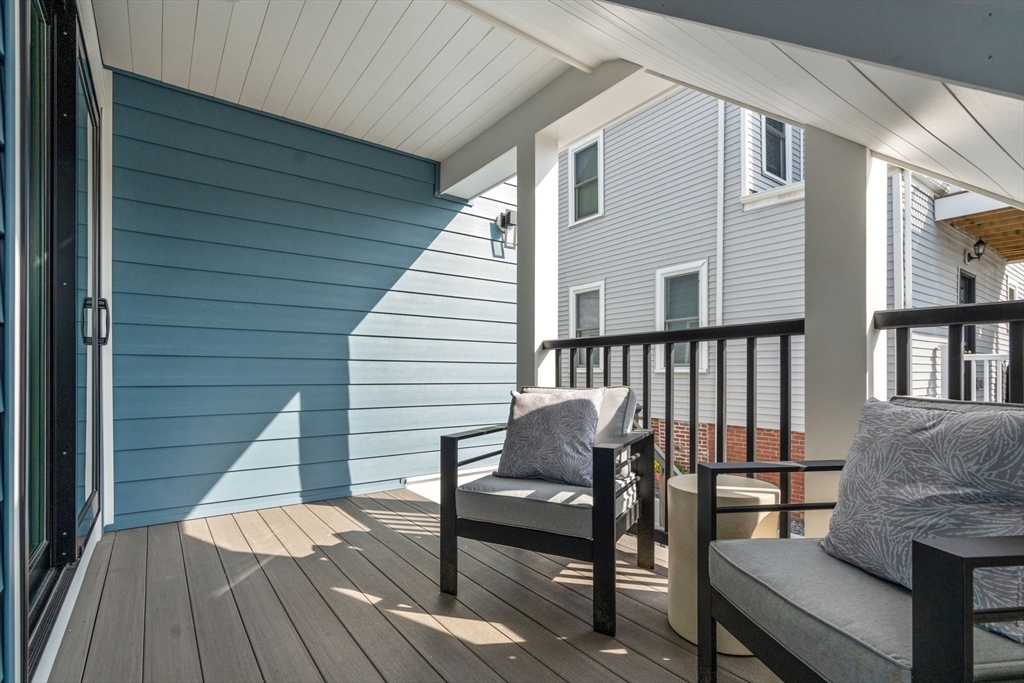 11 Macarthur Street, Unit A Somerville, MA 02145 - Photo 30 of 35 a view of a deck with chairs and wooden floor