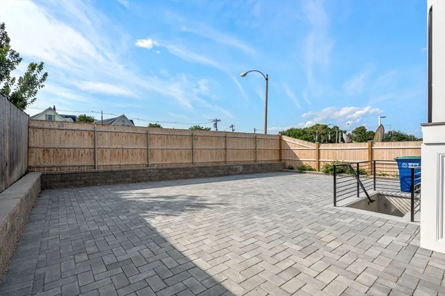 a view of a backyard with wooden fence
