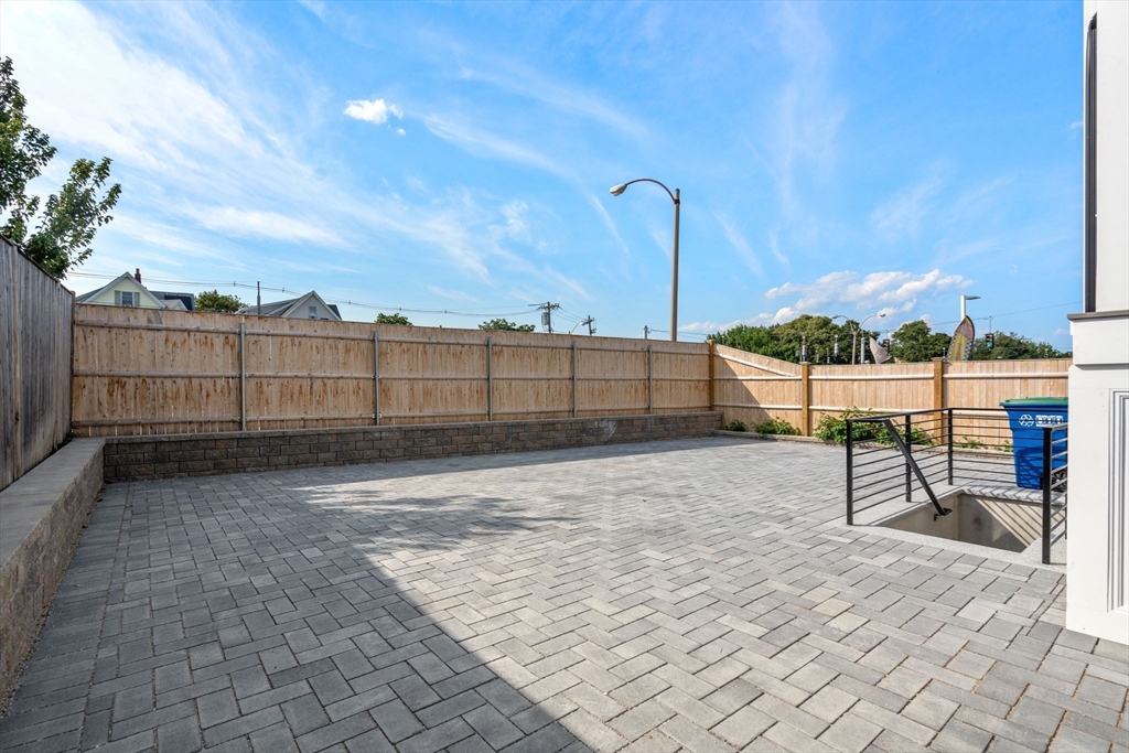11 Macarthur Street, Unit A Somerville, MA 02145 - Photo 31 of 35 a view of a backyard with wooden fence