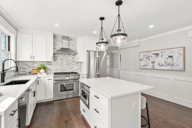 a kitchen with a stove sink and cabinets
