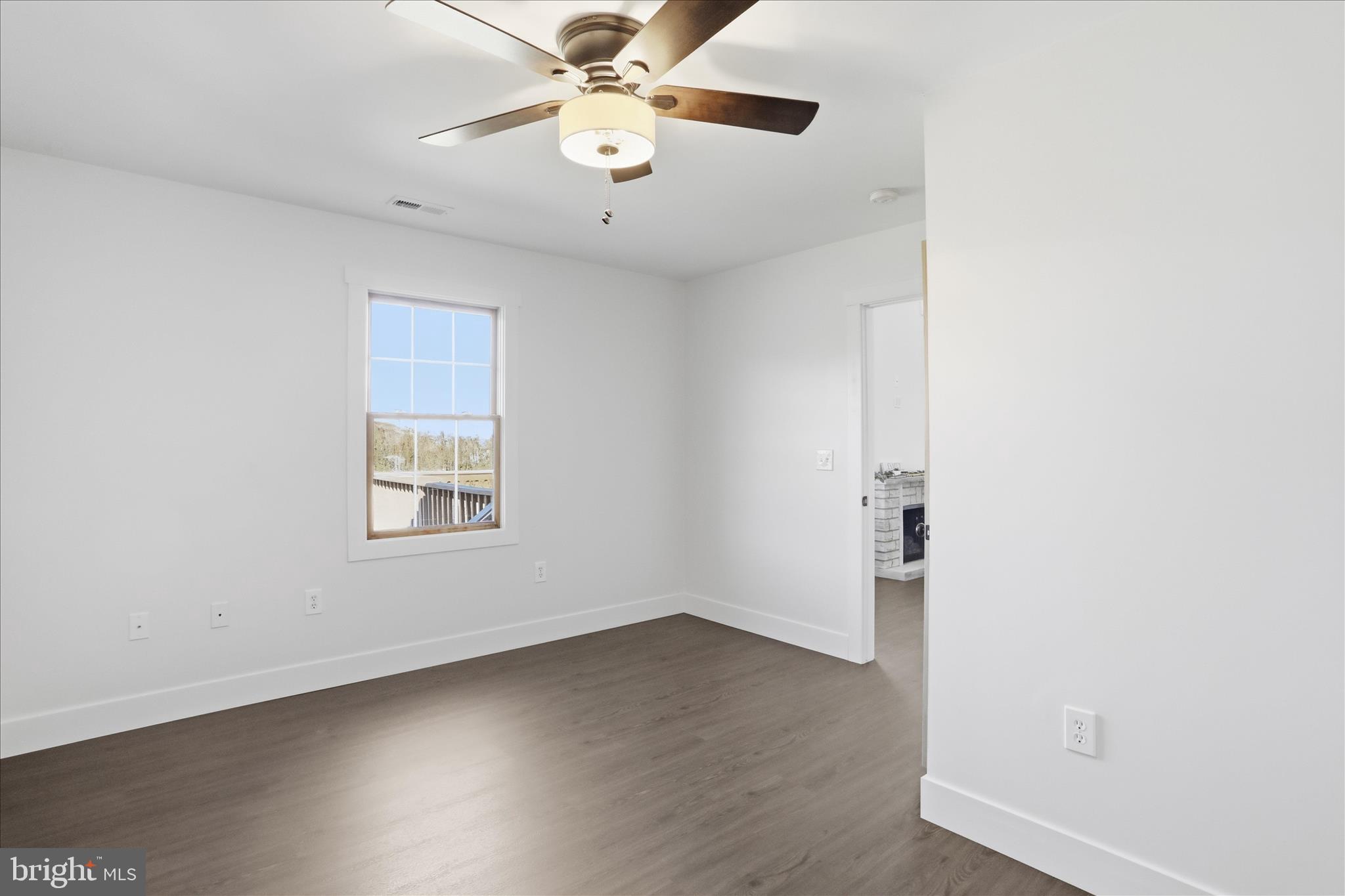 604 Locksa Road Romney, WV 26757 - Photo 21 of 48 an empty room with a window and a fan