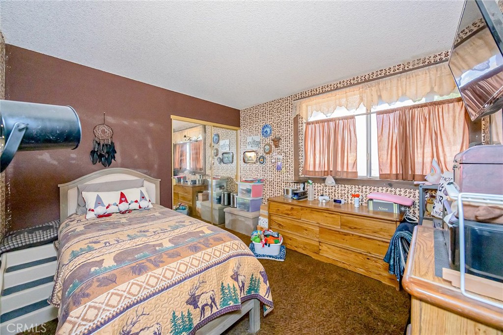 7935 Gardenia Avenue Rancho Cucamonga, CA 91701 - Photo 15 of 35 a bedroom with a bed and a large window