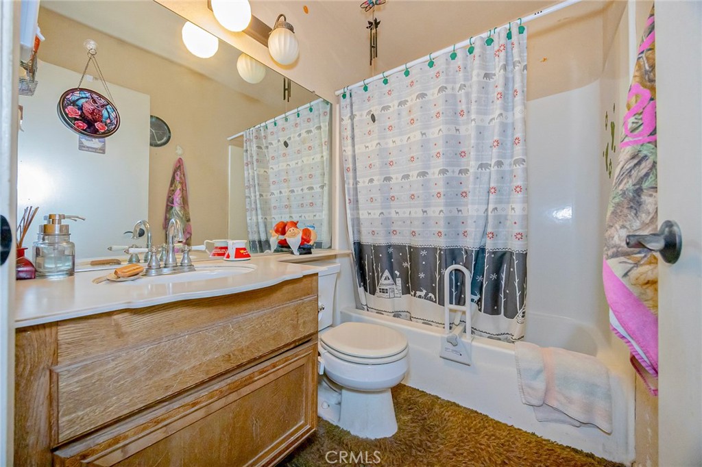 7935 Gardenia Avenue Rancho Cucamonga, CA 91701 - Photo 19 of 35 a bathroom with a sink mirror vanity and toilet