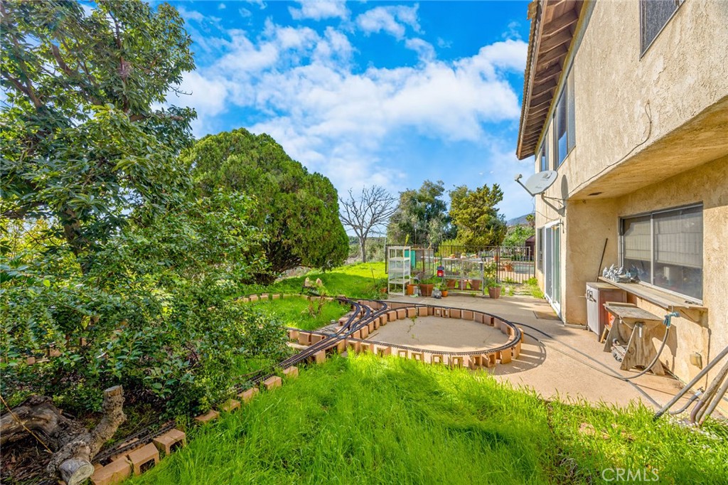 7935 Gardenia Avenue Rancho Cucamonga, CA 91701 - Photo 25 of 35 a view of a patio with a table and chairs under an umbrella