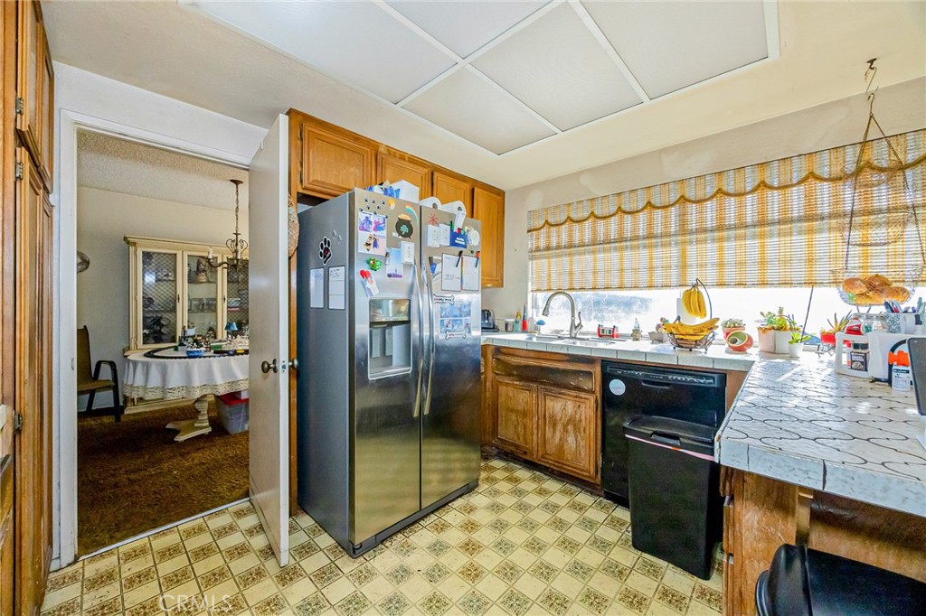 7935 Gardenia Avenue Rancho Cucamonga, CA 91701 - Photo 9 of 35 a kitchen with stainless steel appliances granite countertop sink stove and refrigerator