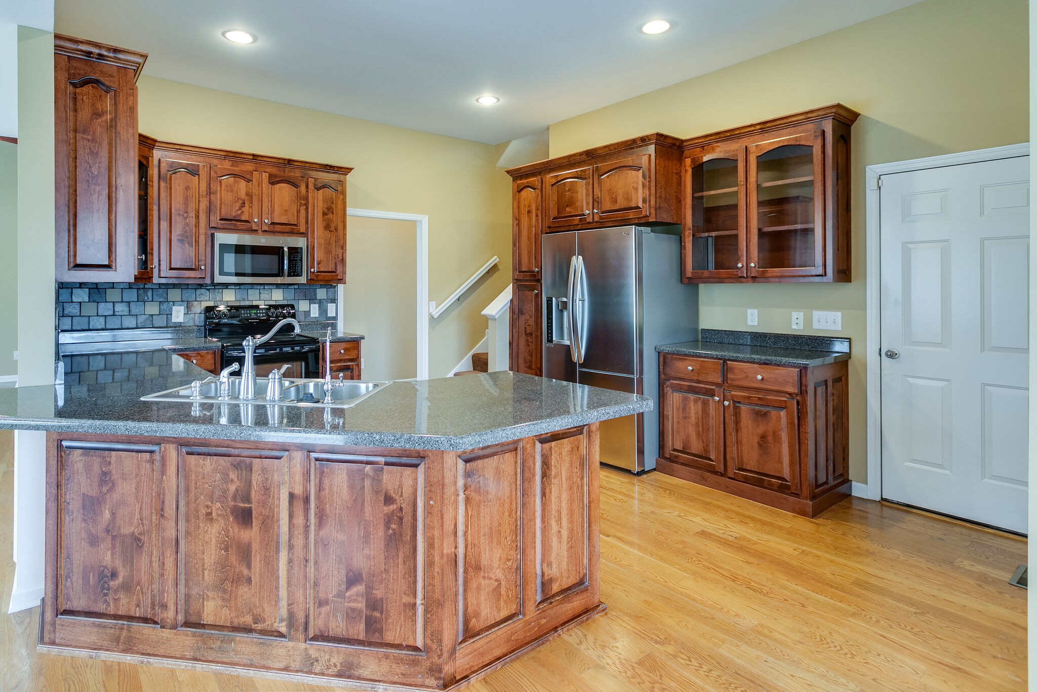 1954 Lasea Road Spring Hill, TN 37174 - Photo 14 of 35 a kitchen with stainless steel appliances granite countertop a refrigerator and a stove top oven