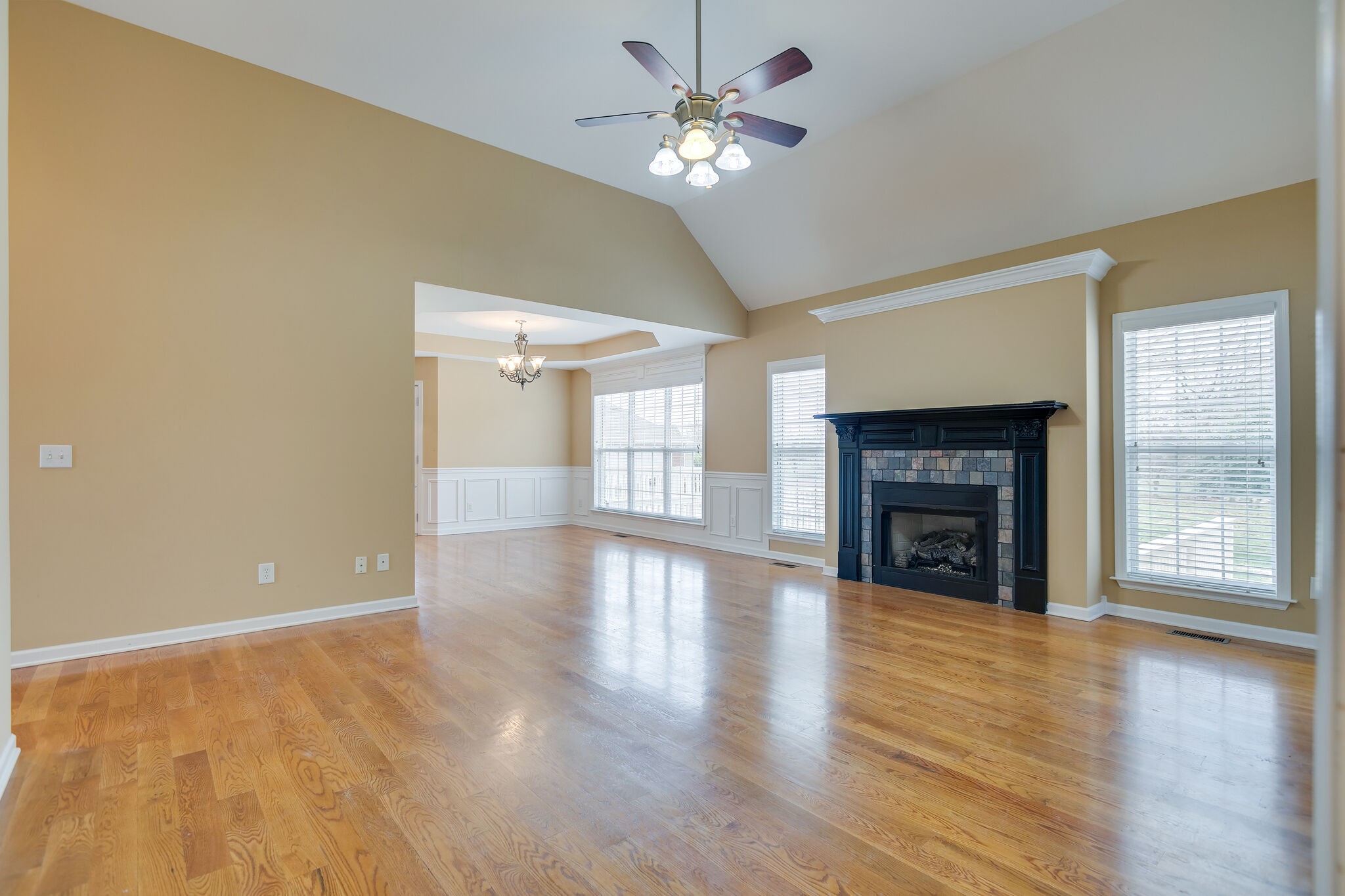1954 Lasea Road Spring Hill, TN 37174 - Photo 8 of 35 a view of an empty room with wooden floor fireplace and a window