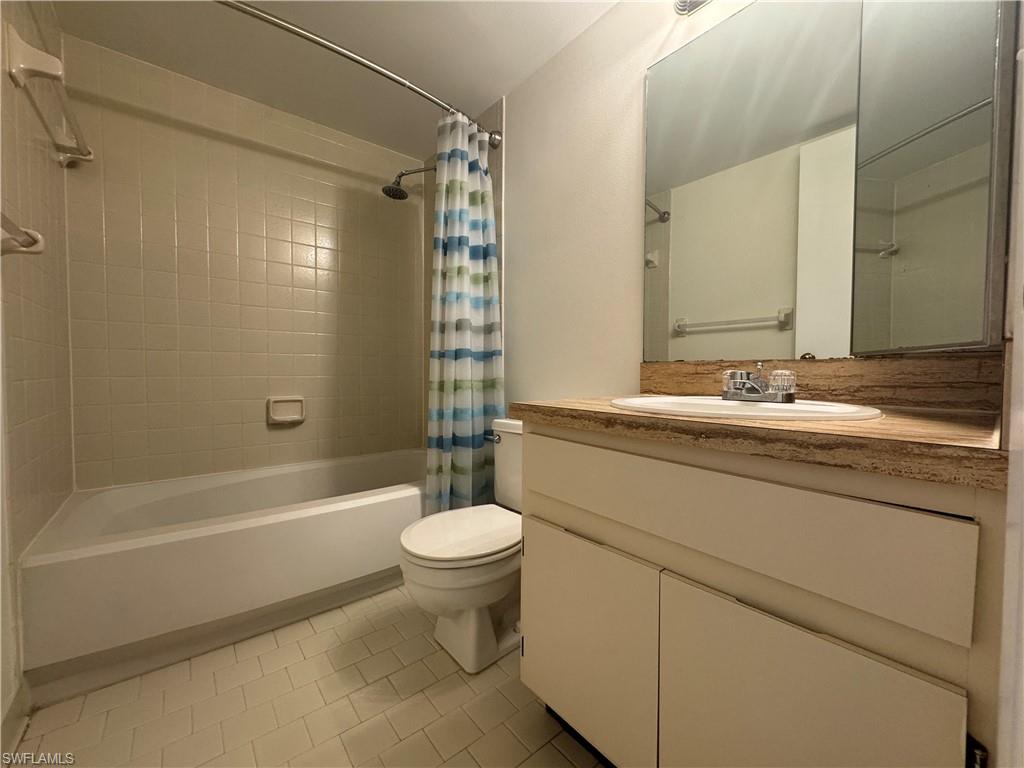 1530 Mainsail Drive, Unit 11 Naples, FL 34114 - Photo 18 of 26 a bathroom with a sink a toilet a mirror a bathtub and shower