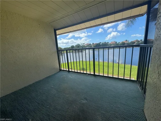 a view of a room with wooden floor and a window