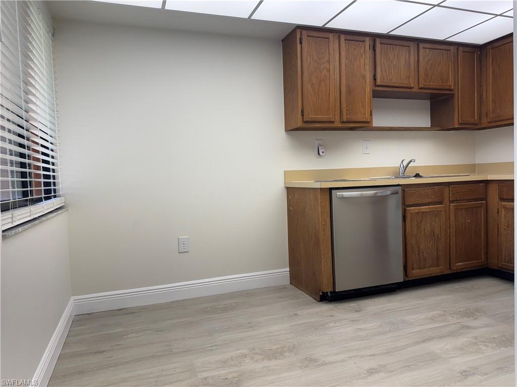 1530 Mainsail Drive, Unit 11 Naples, FL 34114 - Photo 8 of 26 a room with wooden cabinets washer dryer and cabinets