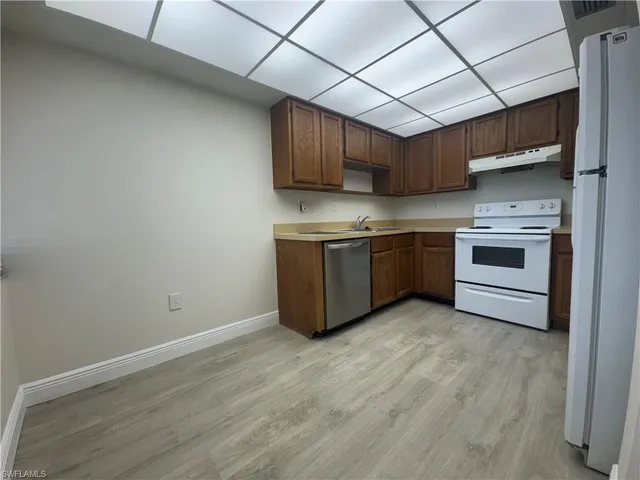 a kitchen with stainless steel appliances granite countertop a stove a sink and a refrigerator