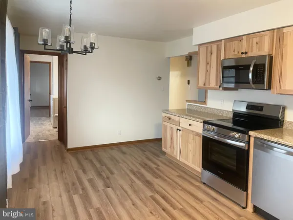 a view of a kitchen with a sink wooden floor and staircase