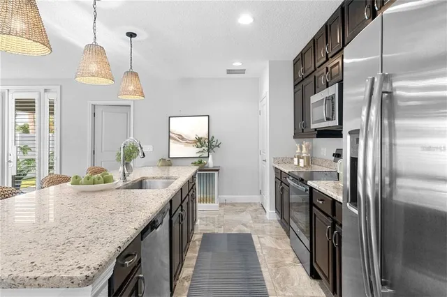a kitchen with stainless steel appliances granite countertop a sink and stove