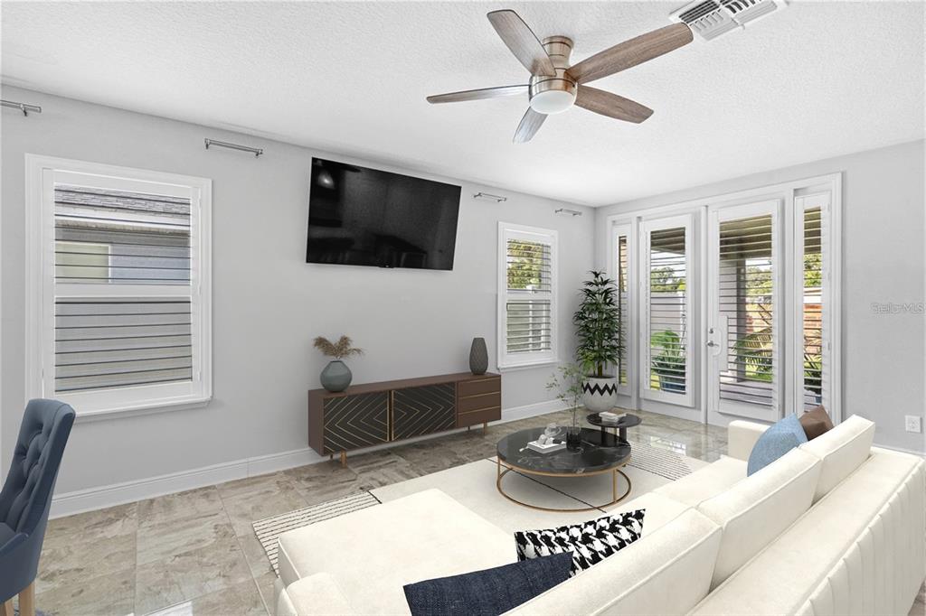 2812 Roseglen Way Orlando, FL 32812 - Photo 6 of 20 a living room with furniture and a flat screen tv