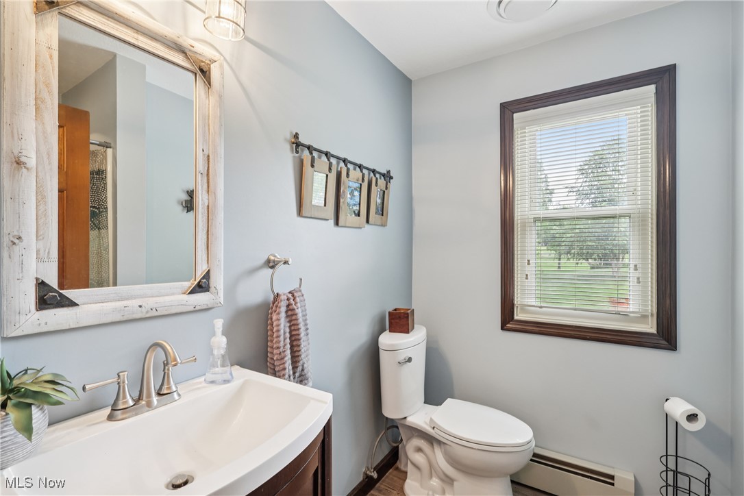4101 Huffman Road Medina, OH 44256 - Photo 17 of 48 Bathroom with a baseboard radiator, vanity, and wood finished floors