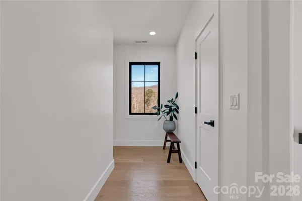 a view of a porch with furniture and wooden floor