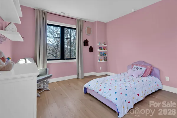 a view of a forest with mountains in the background