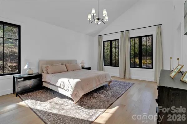 a living room with furniture wooden floor and a flat screen tv