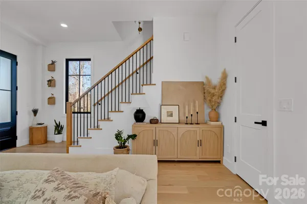 a living room with furniture kitchen view and a chandelier