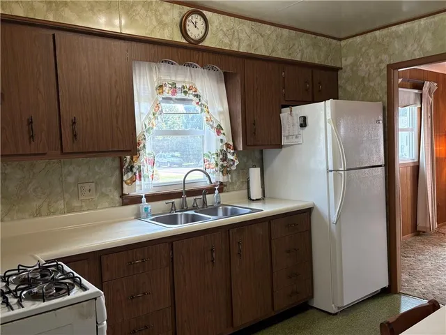 a kitchen with stainless steel appliances a refrigerator and a sink