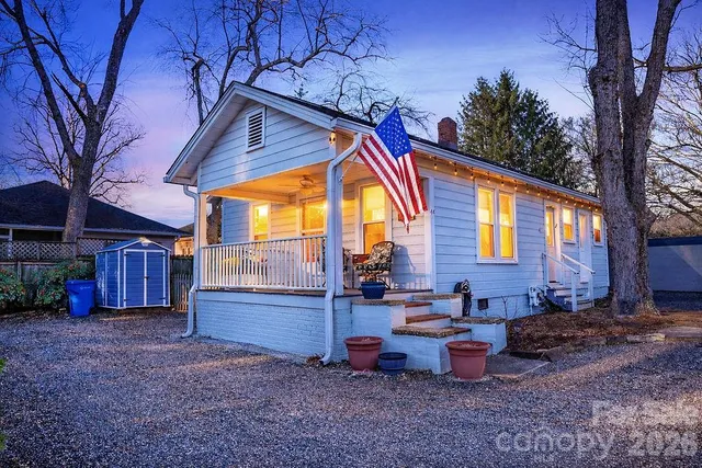 a backyard of a house with barbeque oven table and chairs