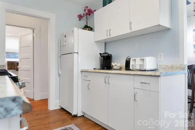 a kitchen with stainless steel appliances a refrigerator and cabinets
